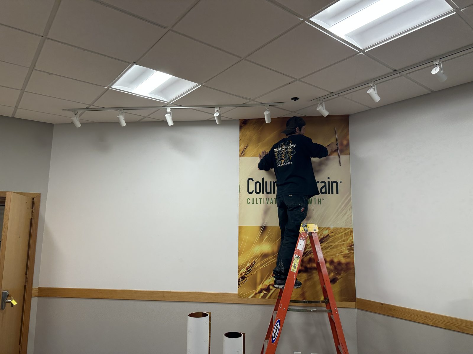 Wall graphic being installed on site