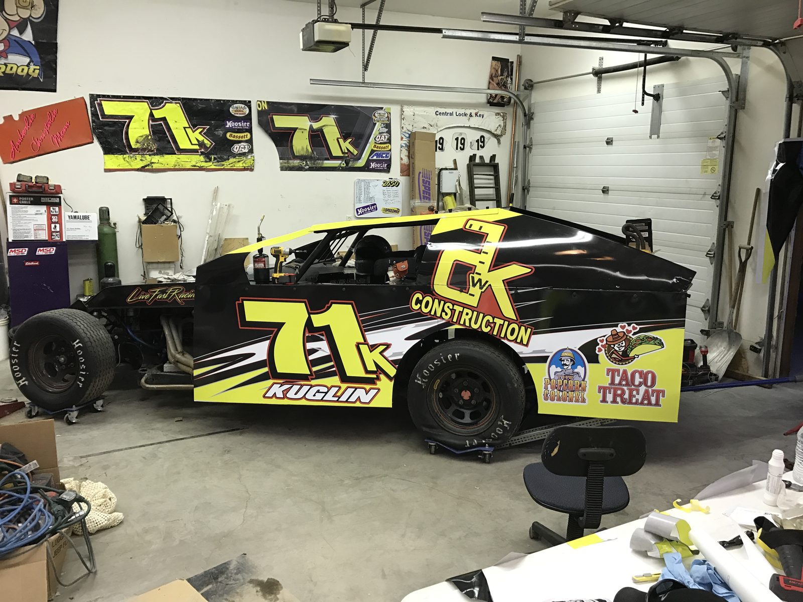 Late model race car with sponsor graphics